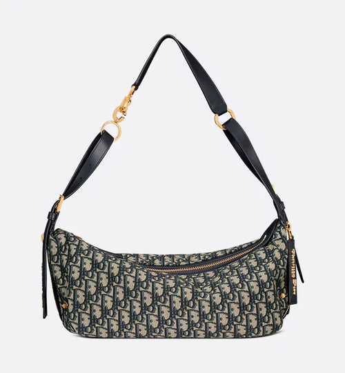 Patterned handbag with a black strap on a light gray background